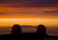As the sky turns red, the twin Keck domes appear to watch the sun set. - Pablo McLoud