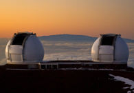 The sun sets on Mauna Kea as the twin Kecks prepare for observing. Haleakala lies in the distance. - Pablo McLoud