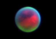 Near-infrared color composite image of Saturn’s largest moon Titan taken with the Keck II adaptive optics system. Titan’s surface appears red, while haze layers at progressively higher altitudes in the atmosphere appear green and blue. - W. M. Keck Observatory/SRI/New Mexico State University
