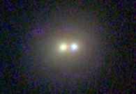 This galaxy (CDF-S:[MBR2003]H_0941) contains two nuclei, indicating a recent galaxy-galaxy collision. The right-hand nucleus is slightly bluer than its partner. The galaxy is an X-ray source and is 4.6 billion light years away. This three color image combines optical light from the Hubble space telescope with infrared light from the Keck laser guide star system. - Hubble Space Telescope/W. M. Keck Observatory